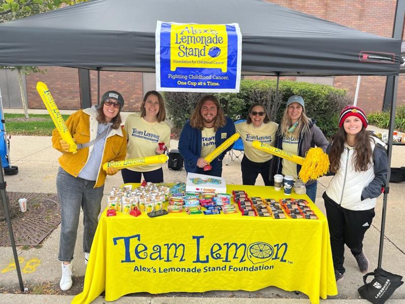 a group of people standing under a tent