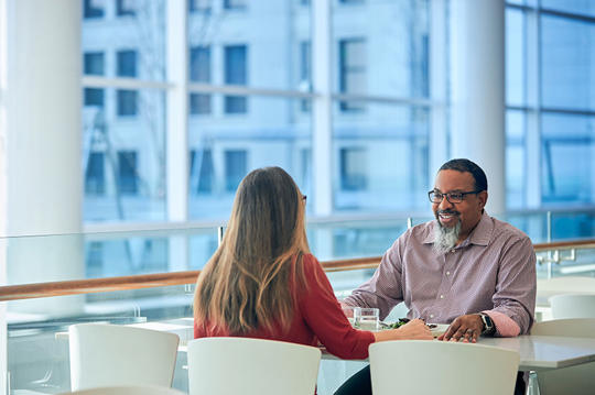 a person and person sitting at a table