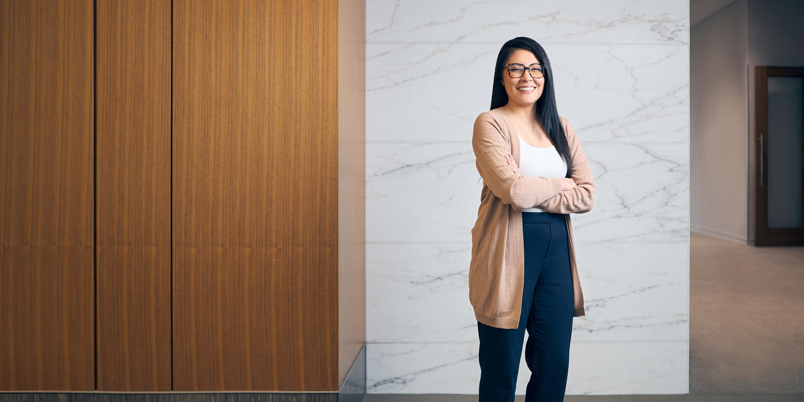a person standing with her arms crossed