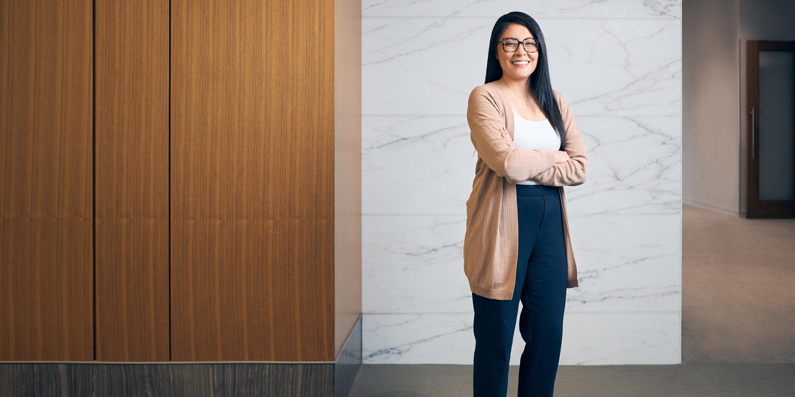 a person standing with her arms crossed