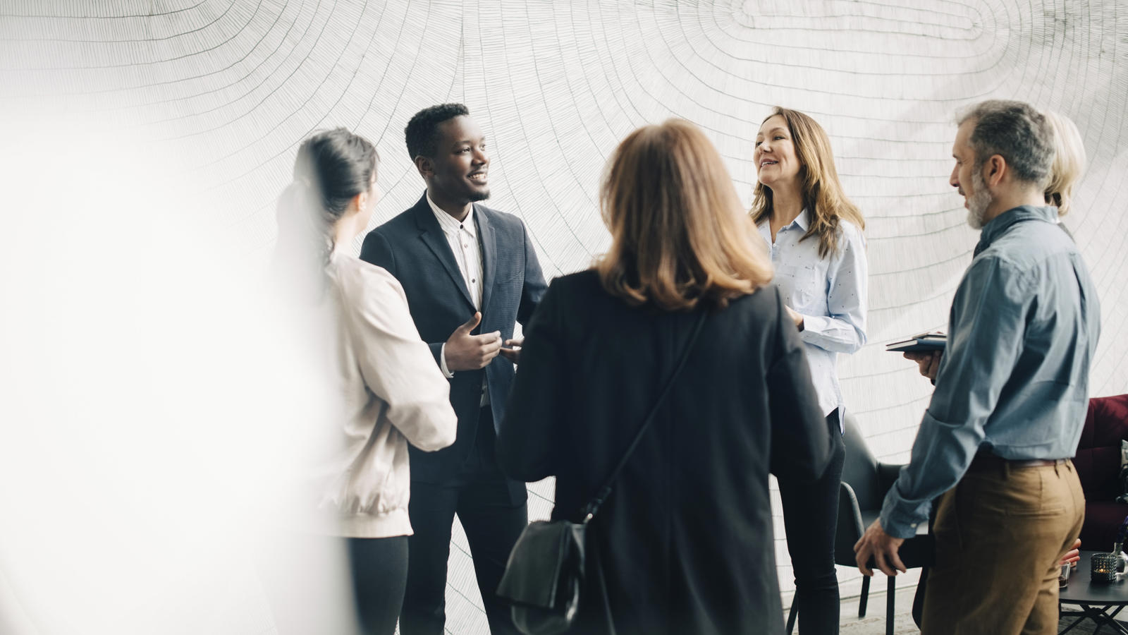a group of people standing in front of a wall