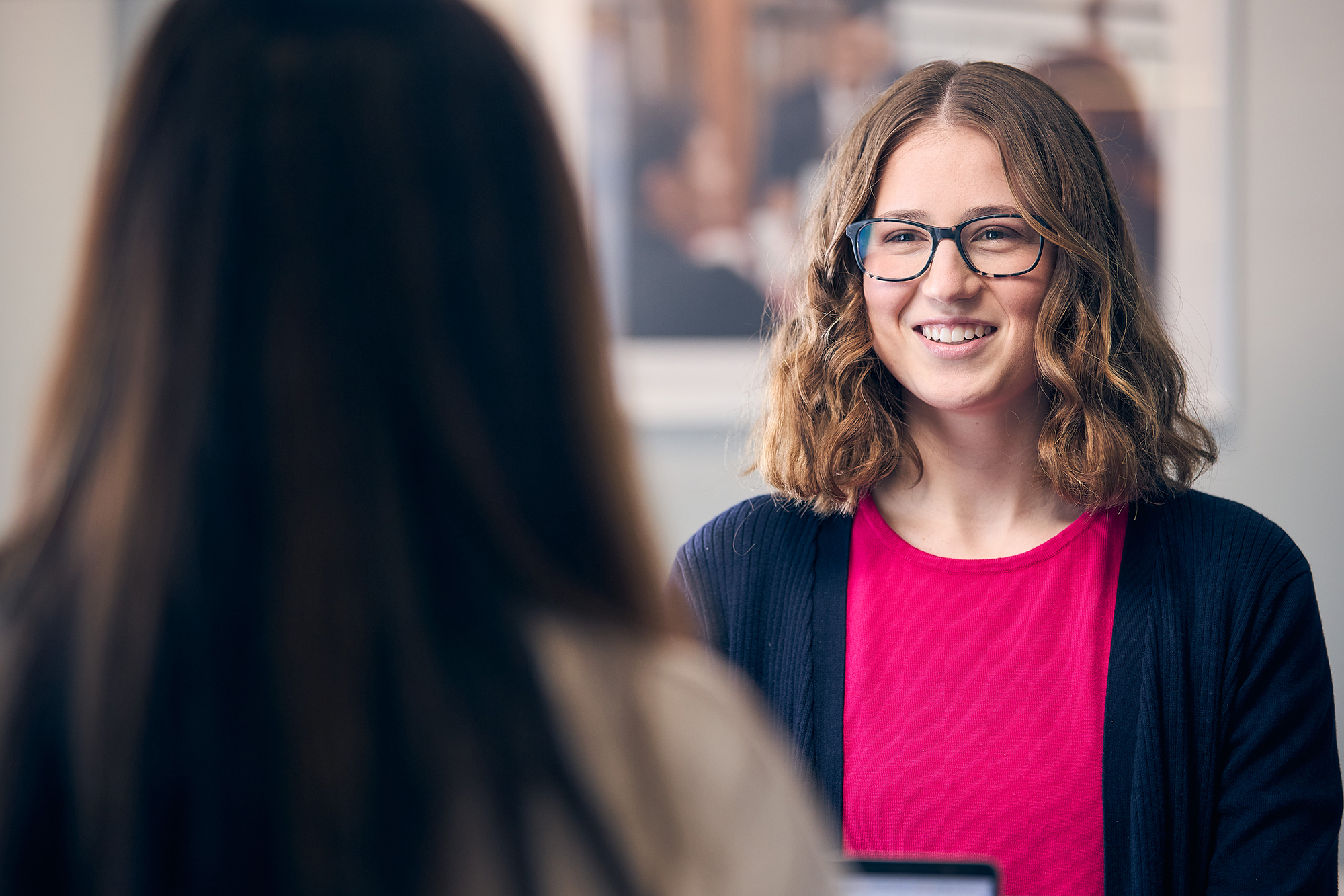 a person wearing glasses and smiling