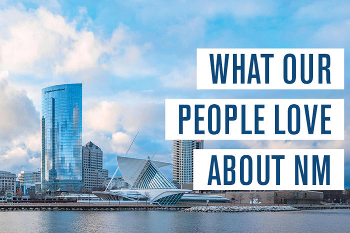 a city with a body of water and a blue sky