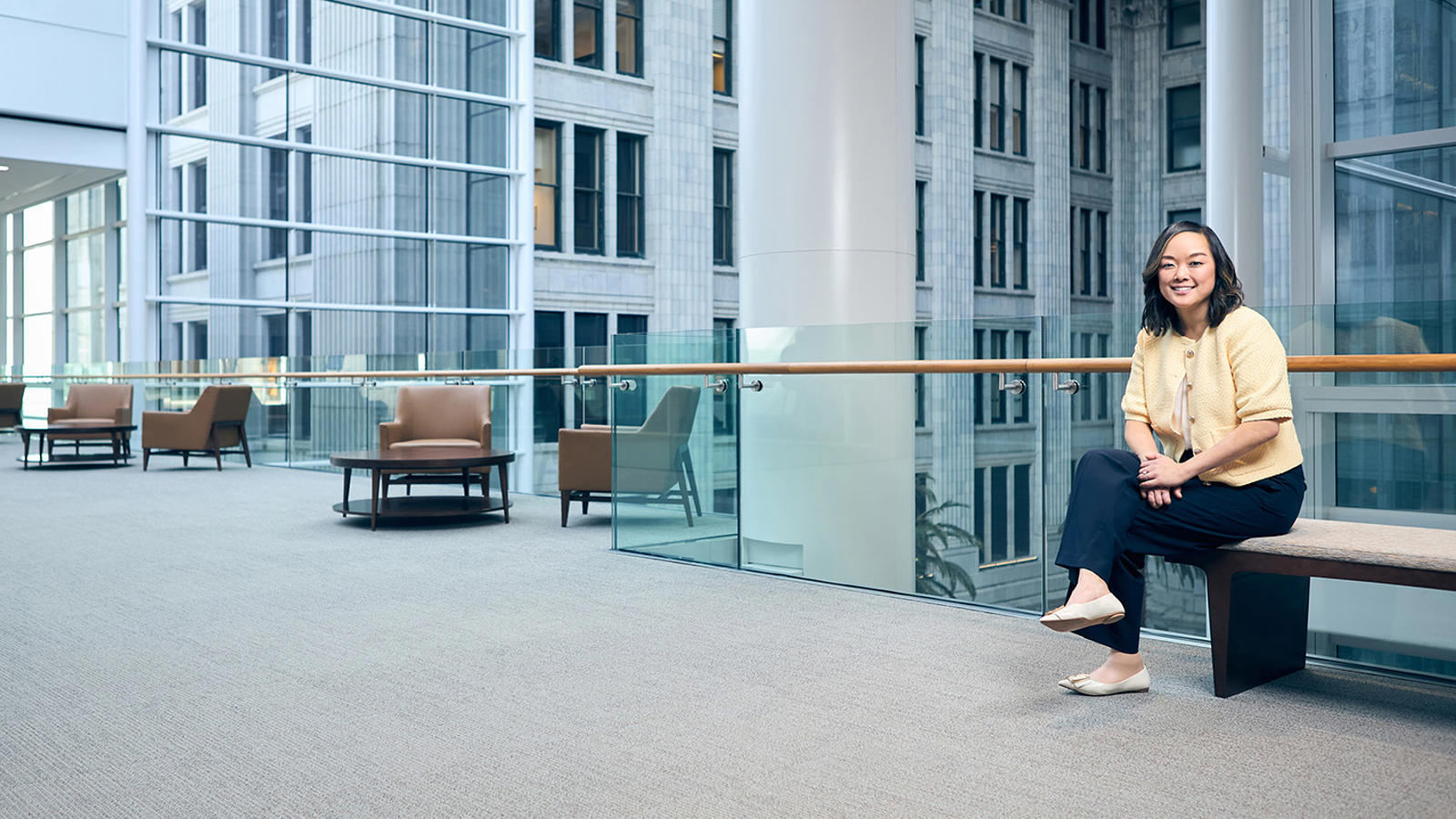 a person standing in a room with a glass railing